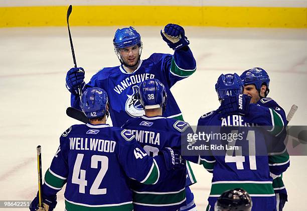Steve Bernier of the Vancouver Canucks celebrates with teammates Kyle Wellwood, Pavol Demitra, Andrew Alberts and Kevin Bieksa after scoring against...