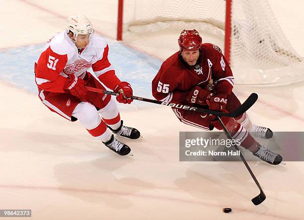 Ed Jovanovski of the Phoenix Coyotes skates with the puck against Valtteri Filppula of the Detroit Red Wings in Game Five of the Western Conference...