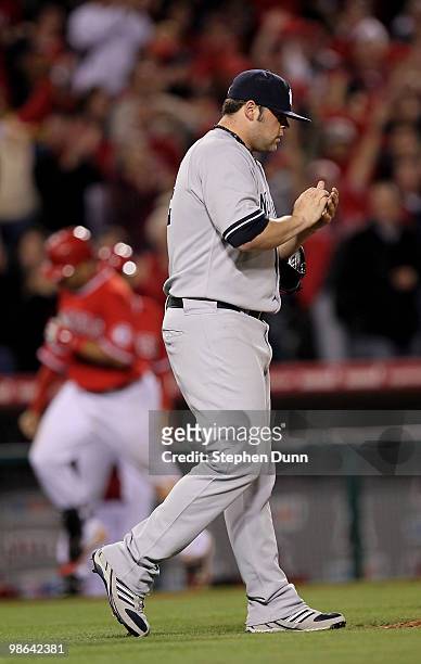 Pitcher Joba Chamberlain of the New York Yankees reacts as Kendry Morales of the Los Angeles Angels of Anaheim circles the bases after hitting a tie...