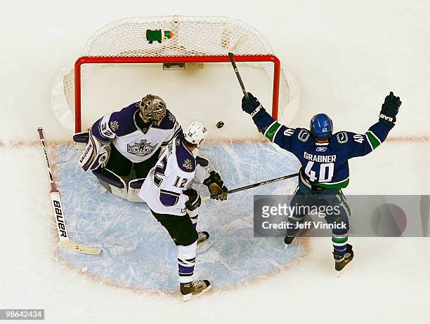 Randy Jones and Jonathan Quick of the Los Angeles Kings look on as Michael Grabner of the Vancouver Canucks celebrates a goal in Game Five of the...