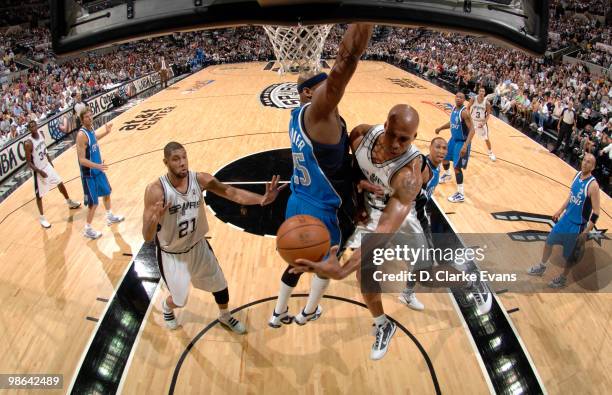 Richard Jefferson of the San Antonio Spurs passes to Tim Duncan of the San Antonio Spurs shoots against Erick Dampier of the Dallas Mavericks in Game...