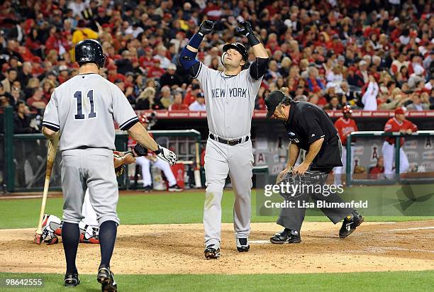 Nick Swisher of the New York Yankees celebrates after hitting a homerun in the fourth inning against the Los Angeles Angels of Anaheim on April 23,...