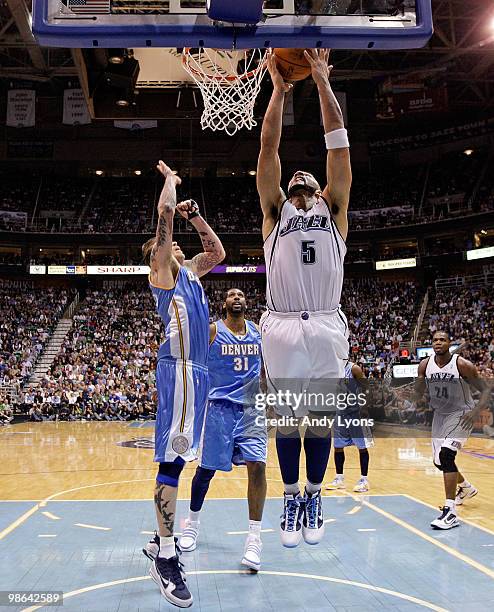 Carlos Boozer of the Utah Jazz shoots the ball while defended by Chris Anderson of the Denver Nuggets during Game 3 of the Western Conference...