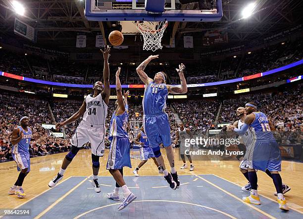 Miles of the Utah Jazz shoots the ball while defended by Chris Anderson of the Denver Nuggets during Game 3 of the Western Conference Quarterfinals...