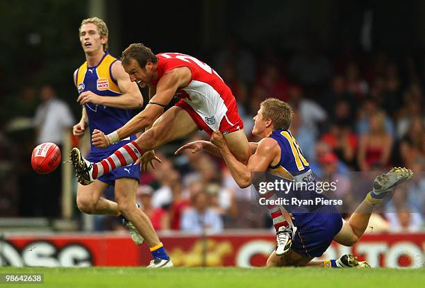 Jude Bolton of the Swans gets his kick away despite the tackle of Scott Selwood of the Eagles during the round five AFL match between the Sydney...