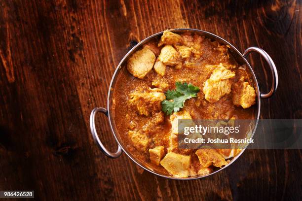 overhead photo of a batli dish with indian butter chicken curry - butter dish stock pictures, royalty-free photos & images