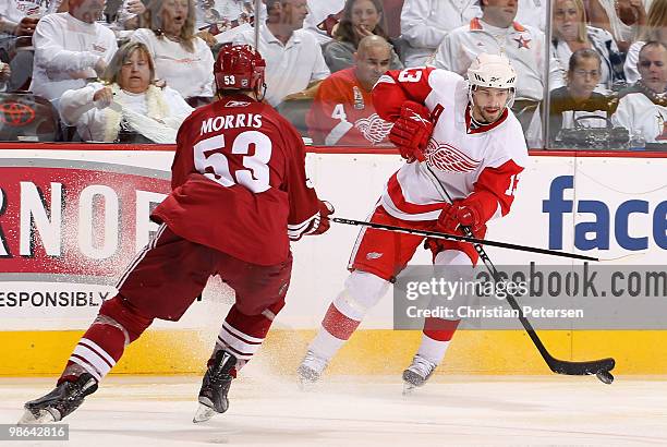 Pavel Datsyuk of the Detroit Red Wings handles the puck under pressure from Derek Morris of the Phoenix Coyotes in Game Five of the Western...