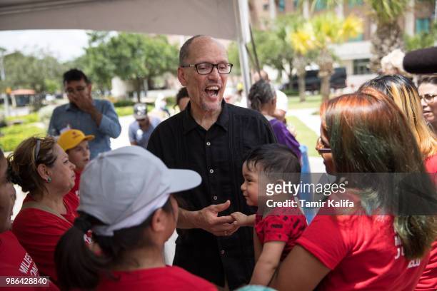Democratic National Committee Chairman Tom Perez speaks with demonstrators at a rally against the Trump administration's immigration policies at...