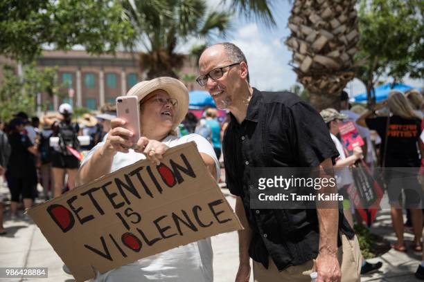 Christy Callahan takes a photo with Democratic National Committee Chairman Tom Perez at a rally against the Trump administration's immigration...