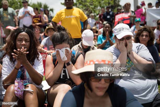 Lakee Babineaux, Jill Woods and Nadine Casteel are overcome with emotion as the recording of children crying at a U.S. Customs and Border Protection...