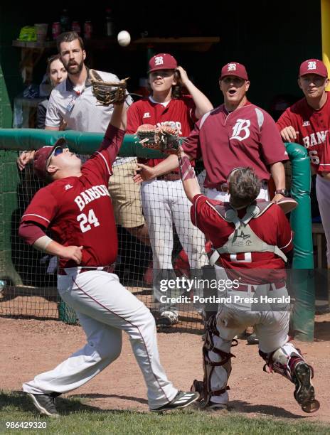 Bangor first baseman Noah Missbrenner and catcher Tyler Parke chase after a foul ball during the Class A state baseball championship against Gorham...