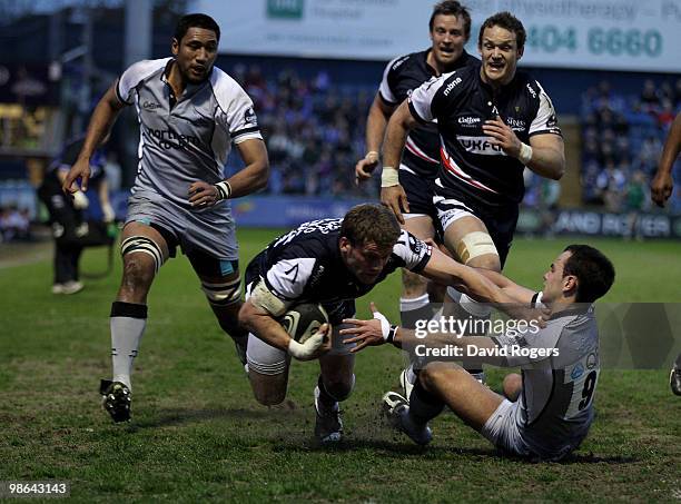 Mark Cueto of Sale is held by Micky Young during the Guinness Premiership match between Sale Sharks and Newcastle Falcons at Edgeley Park on April...