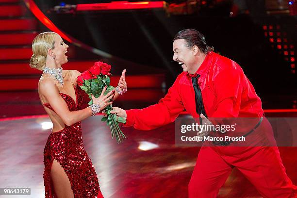 Achim Mentzel gives Sarah Latton flowers during the 'Let's Dance' TV show at Studios Adlershof on April 23, 2010 in Berlin, Germany.