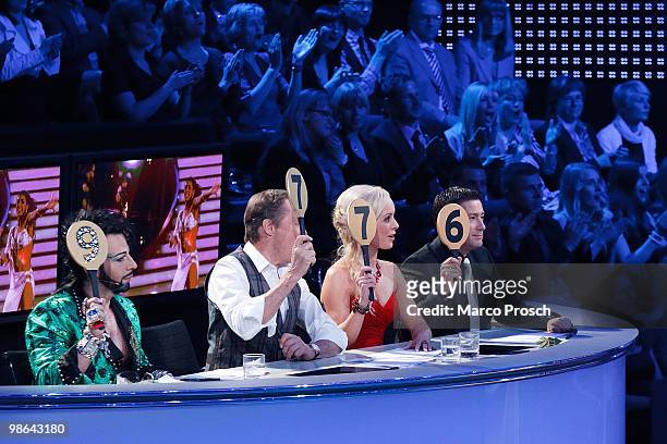Jury members Harald Gloeoeckler, Peter Kraus, Isabel Edvardsson and Joachim Llambi hold numbers evaluating the candidates during the 'Let's Dance' TV...