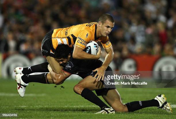 Beau Ryan of the Tigers is tackled by Adrian Purtell of the Panthers during the round seven NRL match between the Penrith Panthers and the Wests...