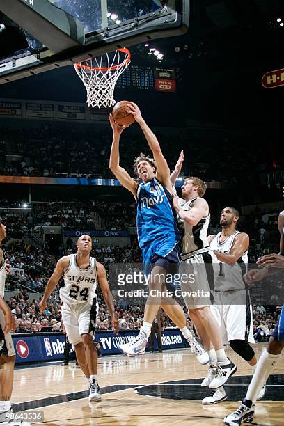 Dirk Nowitzki the Dallas Mavericks leaps to the hoop while being defended by Matt Bonner of the San Antonio Spurs in Game Three of the Western...