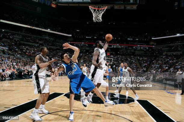 DeJuan Blair of the San Antonio Spurs grabs a rebound over Eduardo Najera of the Dallas Mavericks in Game Three of the Western Conference...