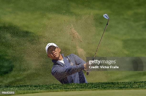 Anthony Kim of USA plays a bunker shot on the 12th hole during the Round Two of the Ballantine's Championship at Pinx Golf Club on April 24, 2010 in...