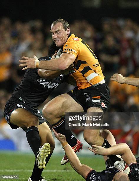 The boot of Gareth Ellis of the Tigers lands on the head of Luke Lewis of the Panthers during the round seven NRL match between the Penrith Panthers...