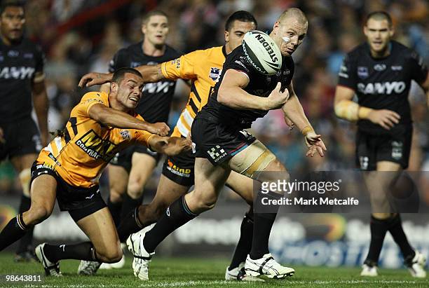 Luke Lewis of the Panthers juggles the ball after breaking through the Tigers defence during the round seven NRL match between the Penrith Panthers...