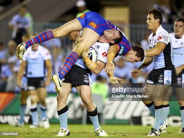 Paul Gallen of the Sharks lifts Cameron Ciraldo of the Knights after being tackled during the round seven NRL match between the Cronulla Sharks and...