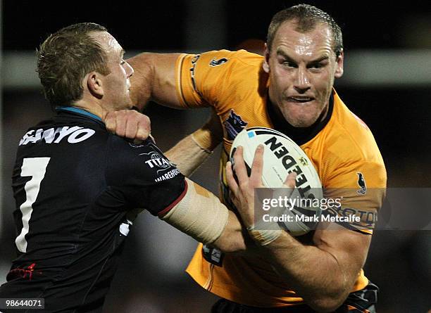 Gareth Ellis of the Tigers is tackled by Luke Walsh of the Panthers during the round seven NRL match between the Penrith Panthers and the Wests...