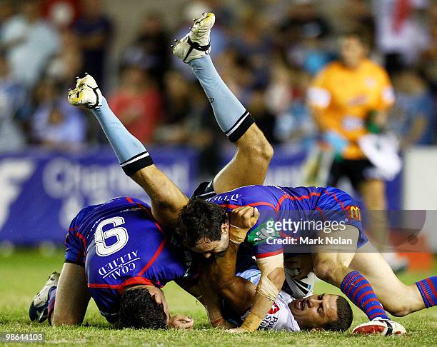 Blake Ferguson of the Sharks is tackled during the round seven NRL match between the Cronulla Sharks and the Newcastle Knights at Toyota Stadium on...