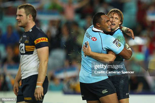 Lachie Turner of the Waratahs is congratulated by team mate Sekope Kepu after scoring a try during the round 11 Super 14 match between the Waratahs...