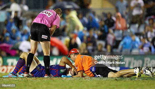 Ben Cross of the Knights receives attention for a neck injury during the round seven NRL match between the Cronulla Sharks and the Newcastle Knights...