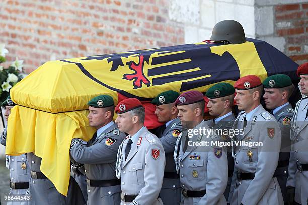 The guards of honor carry a coffin after a funeral service for four killed German ISAF soldiers at the catherdal on April 24, 2010 in Ingolstadt,...