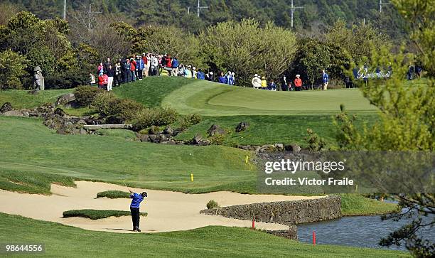 Hong Chang-kyu of South Korea plays a bunker shot on the 18th hole during the Round Two of the Ballantine's Championship at Pinx Golf Club on April...