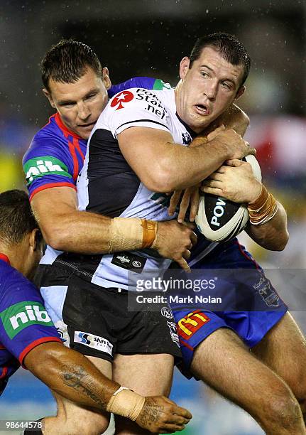Paul Gallen of the Sharks is tackled during the round seven NRL match between the Cronulla Sharks and the Newcastle Knights at Toyota Stadium on...