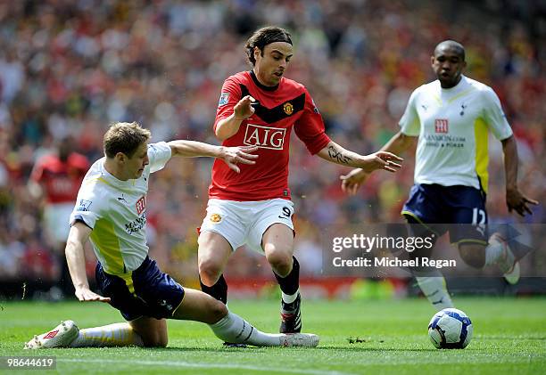 Dimitar Berbatov of Manchester United is tackled by Michael Dawson of Tottenham Hotspur during the Barclays Premier League match between Manchester...