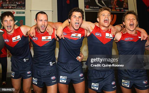 Jack Grimes, Matthew Warnock, Colin Garland, Colin Sylvia and James McDonald of the Demons sing the song in the rooms after winning the round five...