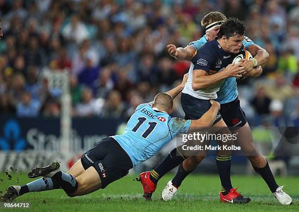 Adam Ashley-Cooper of the Brumbies is tackled during the round 11 Super 14 match between the Waratahs and the Brumbies at ANZ Stadium on April 24,...