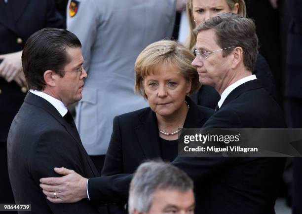 German Defense Minister Karl-Theodor zu Guttenberg, German Chancellor Angela Merkel and German Foreign Minister Guido Westerwelle attend a funeral...