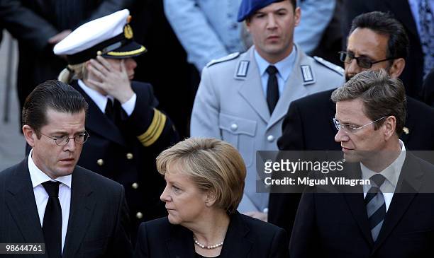 German Defense Minister Karl-Theodor zu Guttenberg, German Chancellor Angela Merkel and German Foreign Minister Guido Westerwelle attend a funeral...