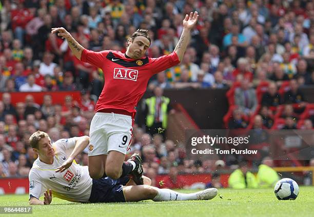 Dimitar Berbatov of Manchester United clashes with Michael Dawson of Tottenham Hotspur during the Barclays Premier League match between Manchester...