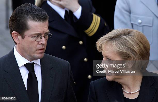 German Defense Minister Karl-Theodor zu Guttenberg and German Chancellor Angela Merkel attend a funeral service for four killed German ISAF soldiers...