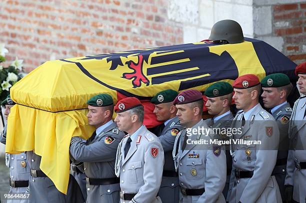 The guards of honor carry a coffin after a funeral service for four killed German ISAF soldiers at the catherdal on April 24, 2010 in Ingolstadt,...