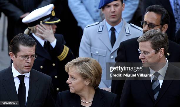 German Defense Minister Karl-Theodor zu Guttenberg, German Chancellor Angela Merkel and German Foreign Minister Guido Westerwelle attend a funeral...