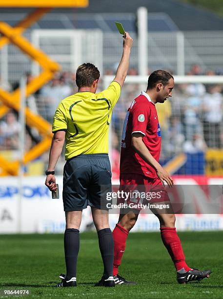 Andreas Spann of 1. FC Heidenheim gets the yellow card by referee Dominik Nowak during the Third League match between Carl Zeiss Jena and 1.FC...