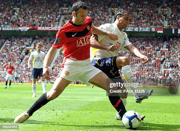 Tottenham Hotspur's Cameroonian defender Benoit Assou-Ekotto closes in on Manchester United's Welsh midfielder Ryan Giggs during their English...
