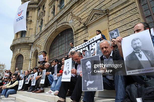 Human rights activists hold pictures of Armenian victims in front of the historical Haydarpasa station at Kadikoy in Istanbul on April 24 during a...