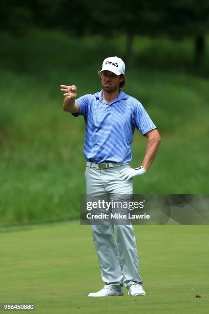 Aaron Baddeley of Australia prepares to play a shot on the sixth hole during the first round of the Quicken Loans National at TPC Potomac on June 28,...