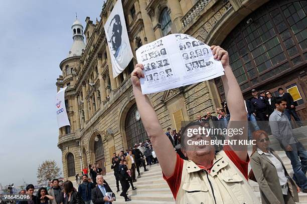 Turkish nationalist holds pictures of Turks killed by the Armenian Secret Army for the Liberation of Armenia in front of the historical Haydarpasa...