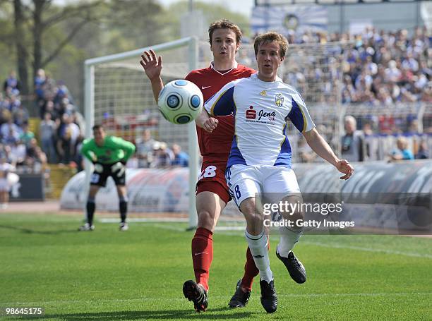 Ralf Schmidt of FC Carl Zeiss Jena and David Schittenhelm of 1. FC Heidenheim battle for the ball- back Goalkeeper Carsten Nulle of FC Carl Zeiss...