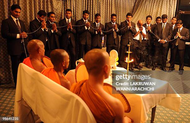 Sri Lankan cricket team members observe Buddhist rituals at the Sri Lanka Cricket headquarters in Colombo on April 24, 2010. The team performed...