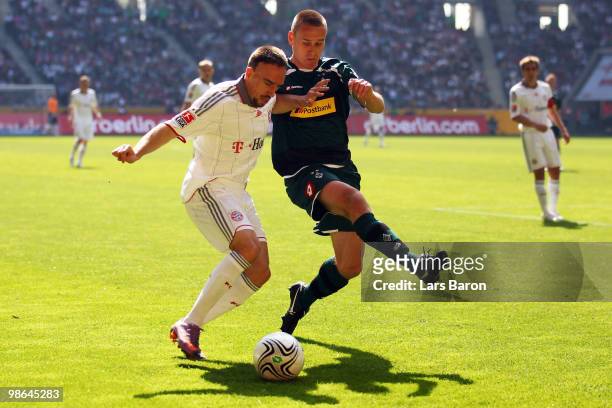 Franck Ribery of Muenchen is challenged by Filip Daems of Moenchengladbach during the Bundesliga match between Borussia Moenchengladbach and FC...
