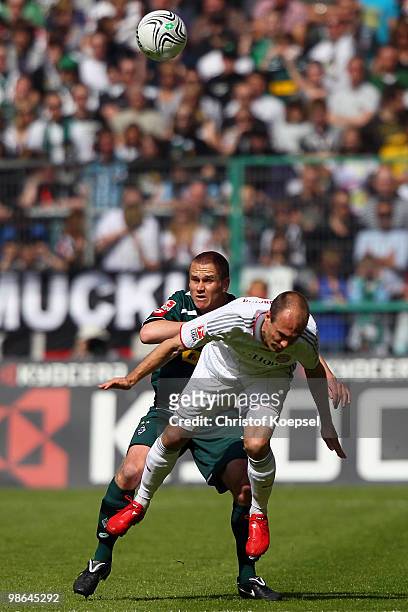 Filip Daems of Gladbach and Arjen Robben of Bayern go up for a header during the Bundesliga match between Borussia Moenchengladbach and FC Bayern...